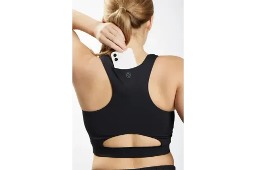 Woman modeling the Tomboy X Cutout Racerback Sports Bra and showing the hiding spot